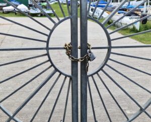 double ornate gate with a chain and padlock on metal gate at sailing club