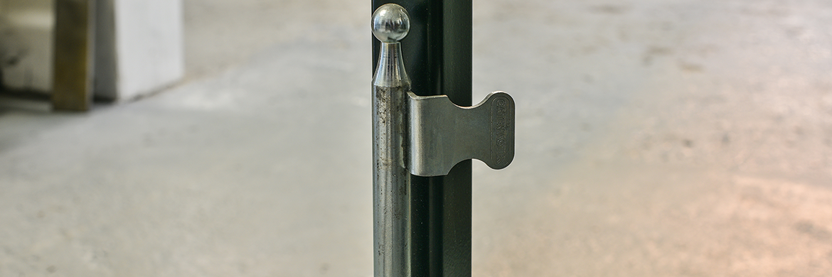 Metal locakable dropbolt fixed to grey metal swing gate