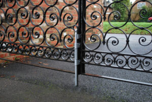 image of drop bolt on ornamental wrought iron driveway gate