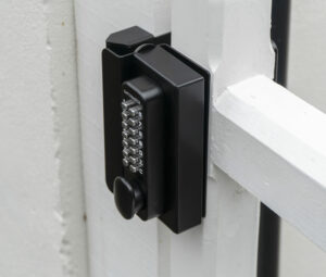 Keyless keypad lock with code installed on white timber driveway gate