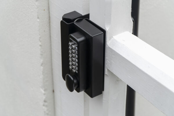 wooden gate with digital keypad lock installed