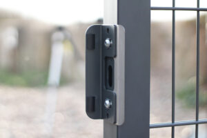 Image of a lock keep attached to grey metal gate.