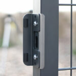 Lock slam plate attached to grey metal gate