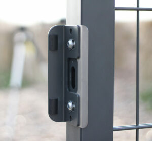 Lock keep and strike plate attached to grey metal gate for lock