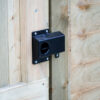 shroud and latch lever handle of Superlatch on wooden gate
