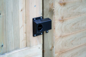 shroud and latch lever handle of Superlatch on wooden timber garden gate