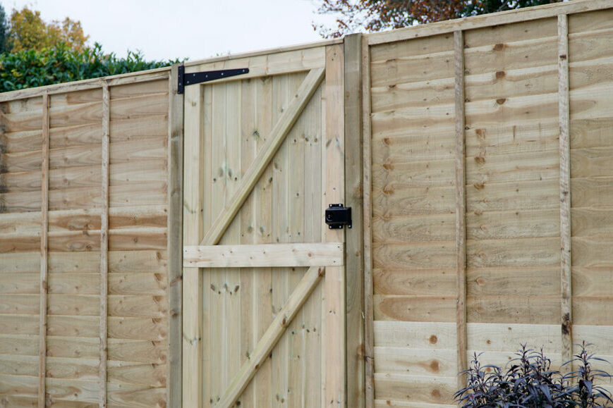 softwood timber panel fencing and gate in garden