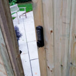 wooden gate with digital keypad lock installed