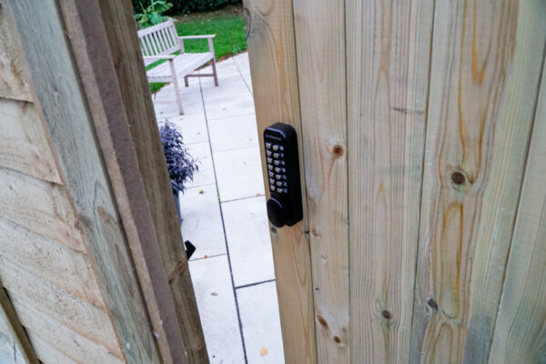 wooden gate with digital keypad lock installed