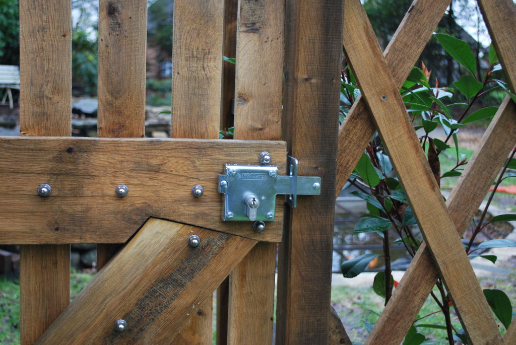 Timber gate with metal locking bolt with wood screw fixings on softwood timber garden gate