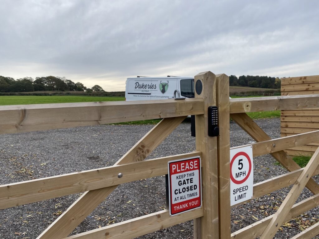 Digital heavy duty keypad lock installed on wooden timber gate at Dukeries Retreat camping and glamping site