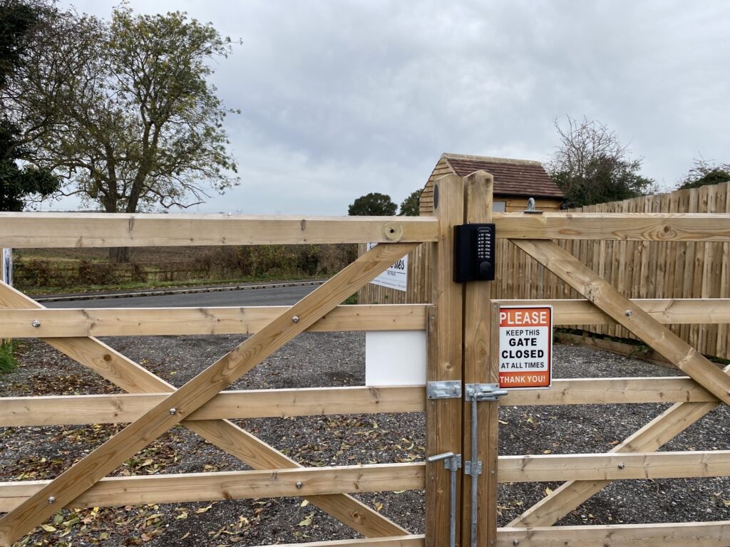 Heavy duty keypad lock with code on large entrance gate to a camping ground