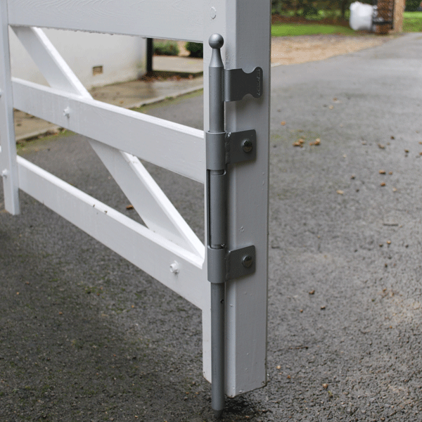 White painted timber gate with screw-fixed auto locking dropbolt fixed to side. In background: paved driveway
