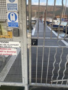 Metal bar gate with digital lock installed at boat yard gates.
