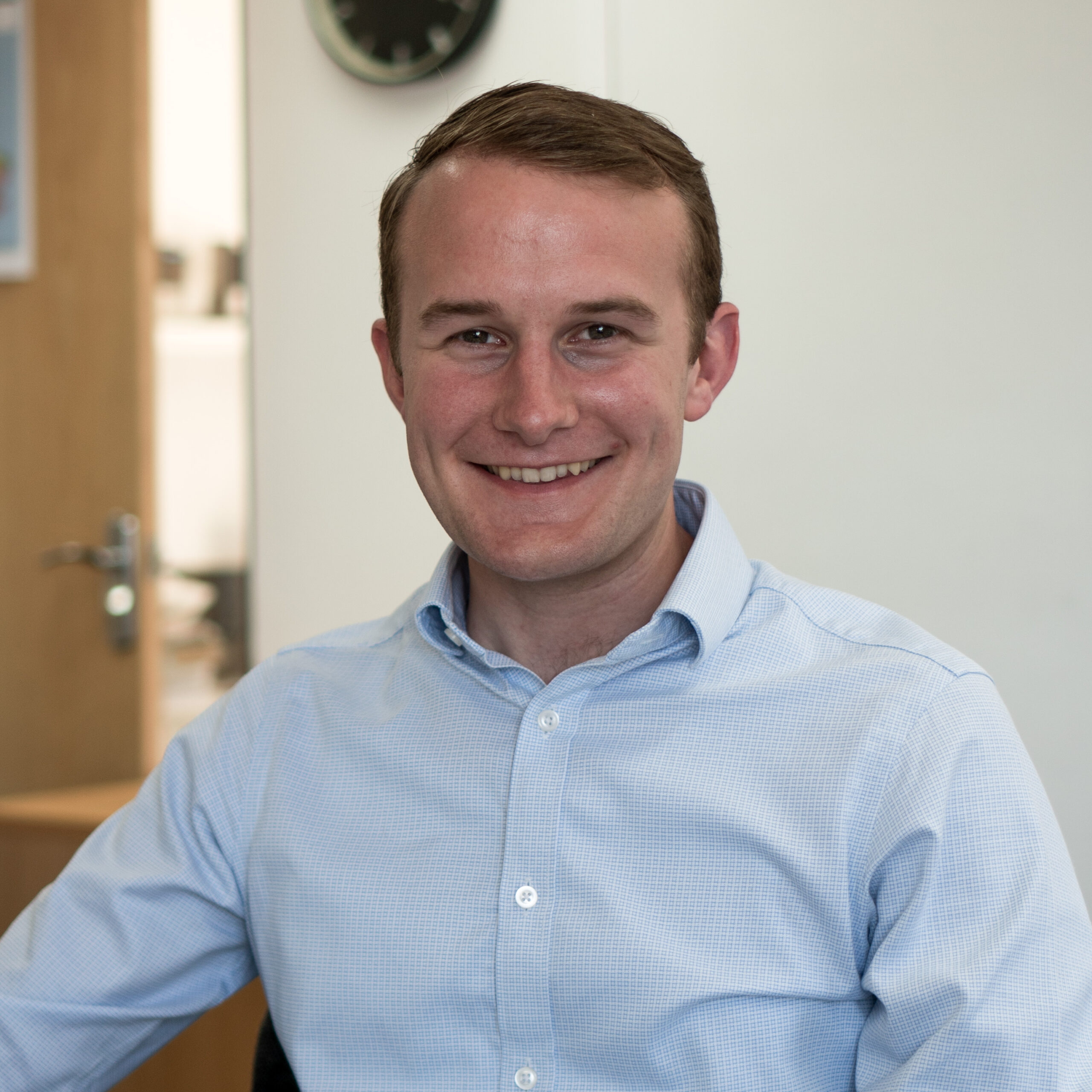 man in blue shirt looking at camera and smiling