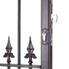 Black metal gate with decorative spears. On front is key cylinder with escutcheon around. On side is a hook latch lock.