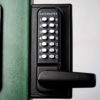 Gate lock on green metal gate post