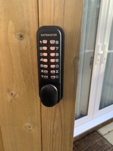 Digital combi lock with keypad installed on wooden timber garden gate fence
