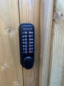 Keypad lock with code installed on wooden timber garden gate