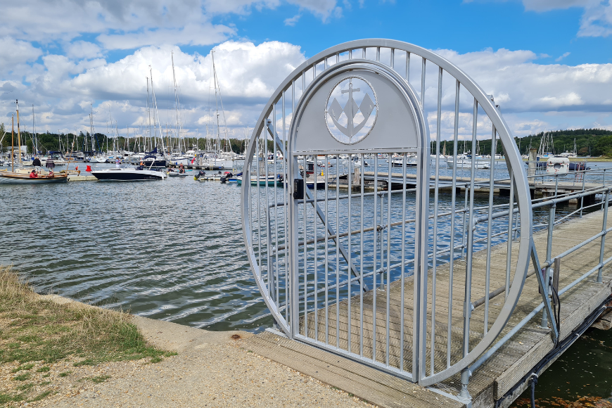Round ornamental gate on boat dock marina with gate hardware for yacht clubs