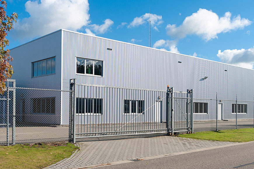 Commercial business unit with sliding gate in front.