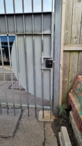 metal gate with security shroud and lock at leisure centre