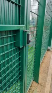 keyless lock on green gate at sports stadium