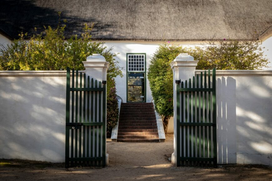 double gate in front of white cottage. how to lock a double gate