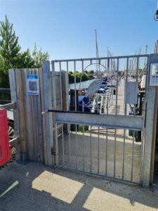 sailing club entrance gate with self-closing gate mechanism installed